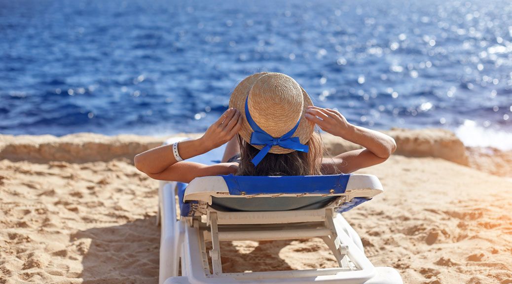 Beautiful woman sunbathing on a beach
